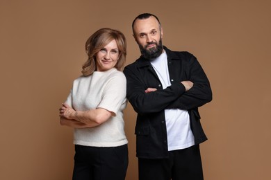 Photo of Portrait of lovely couple on brown background