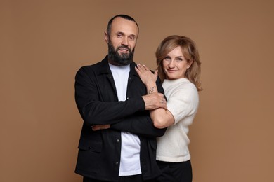 Photo of Portrait of lovely couple on brown background