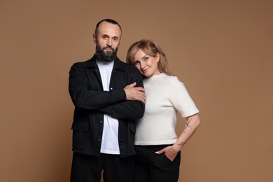 Photo of Portrait of lovely couple on brown background