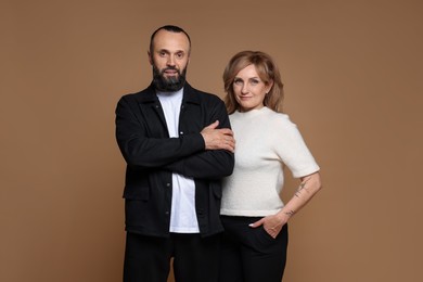 Photo of Portrait of lovely couple on brown background