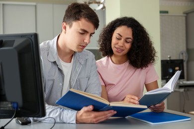 Photo of People studying together at desk in public library