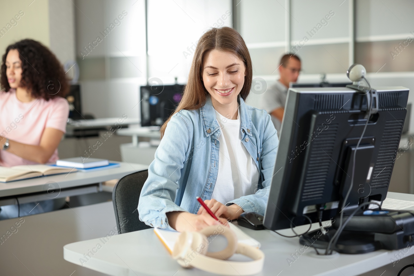 People working at desks in library, selective focus Photo of People working at desks in library, selective focus
