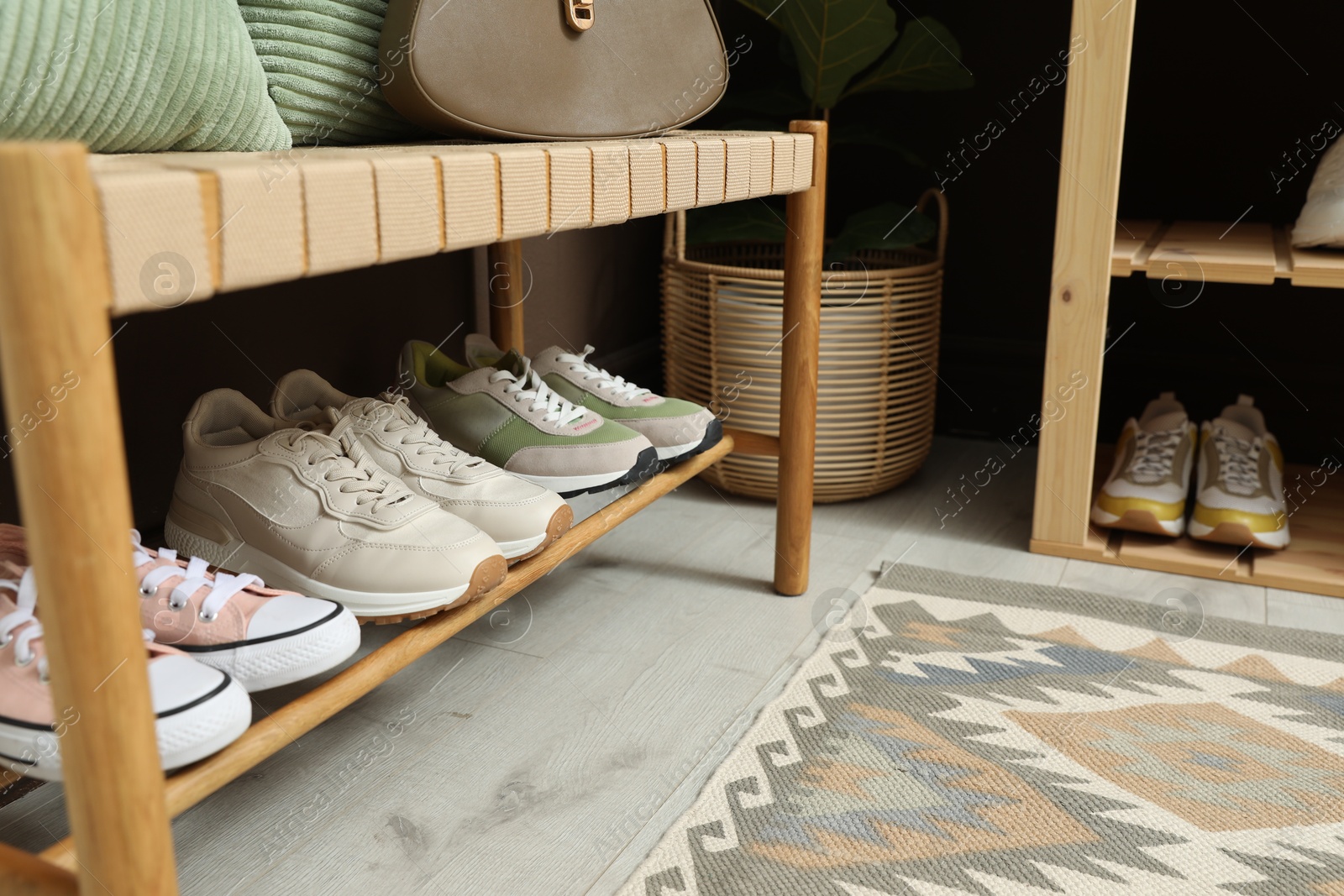 Different footwear on bench indoors. Shoe storage Photo of Different footwear on bench indoors. Shoe storage