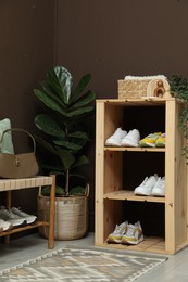 Photo of Different footwear on shelves in entryway. Shoe storage