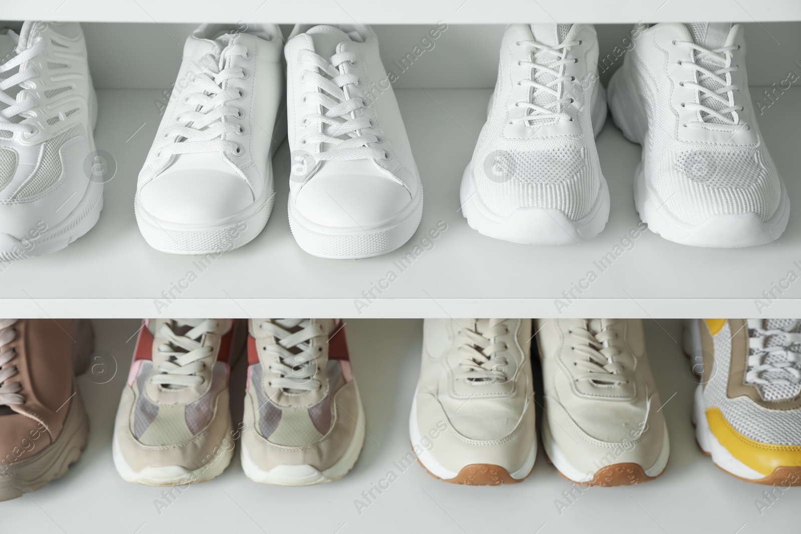 Different footwear on shelves indoors, closeup. Shoe storage Photo of Different footwear on shelves indoors, closeup. Shoe storage