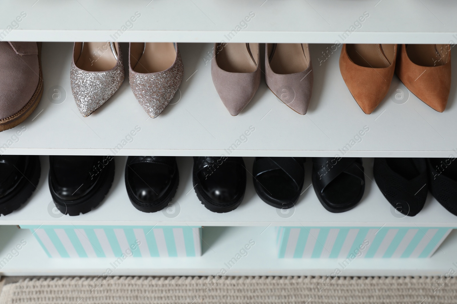 Different footwear on shelves indoors, closeup. Shoe storage Photo of Different footwear on shelves indoors, closeup. Shoe storage