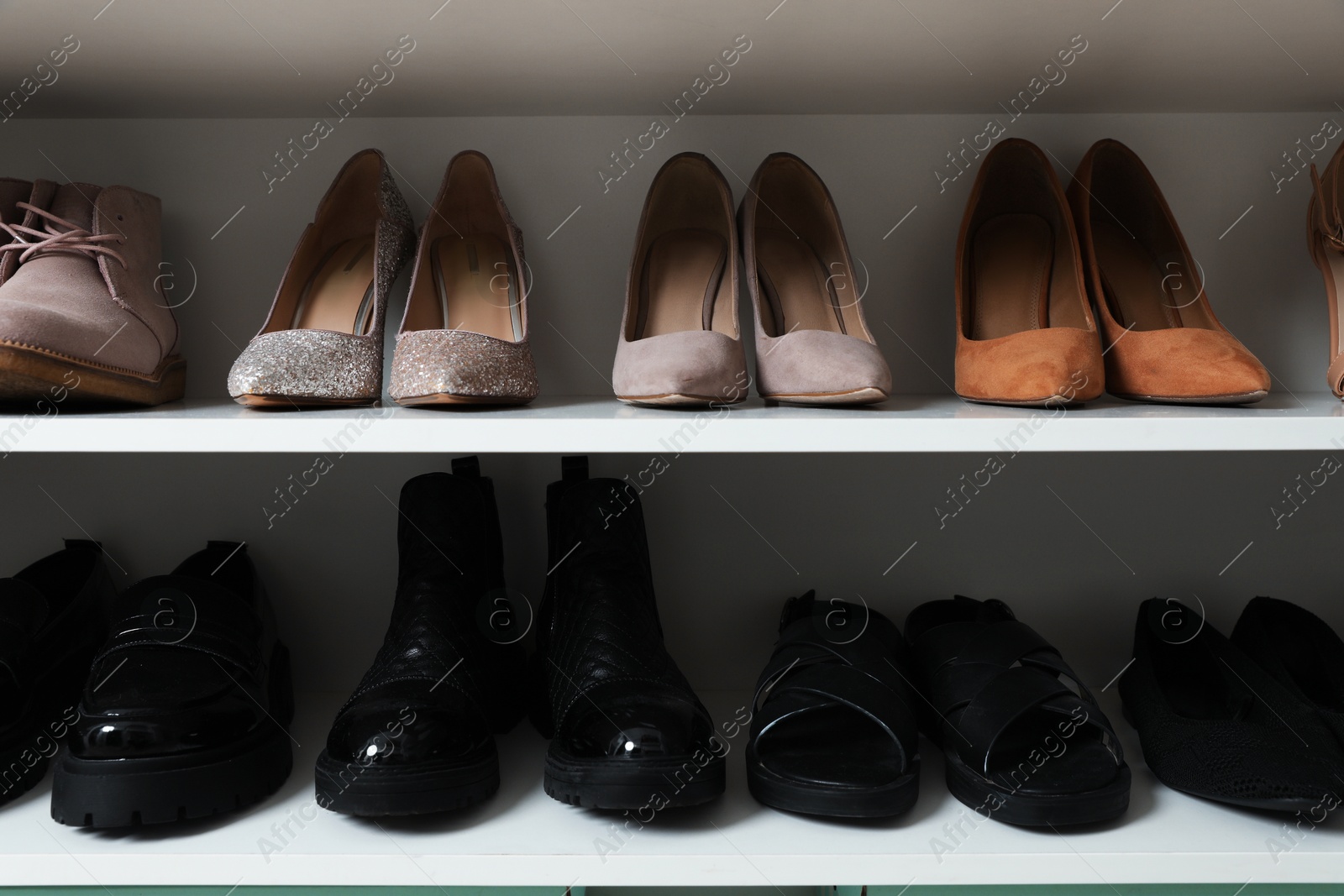 Different footwear on shelves indoors, closeup. Shoe storage Photo of Different footwear on shelves indoors, closeup. Shoe storage