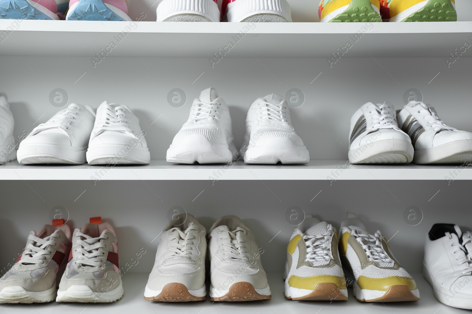 Different footwear on shelves indoors, closeup. Shoe storage Photo of Different footwear on shelves indoors, closeup. Shoe storage