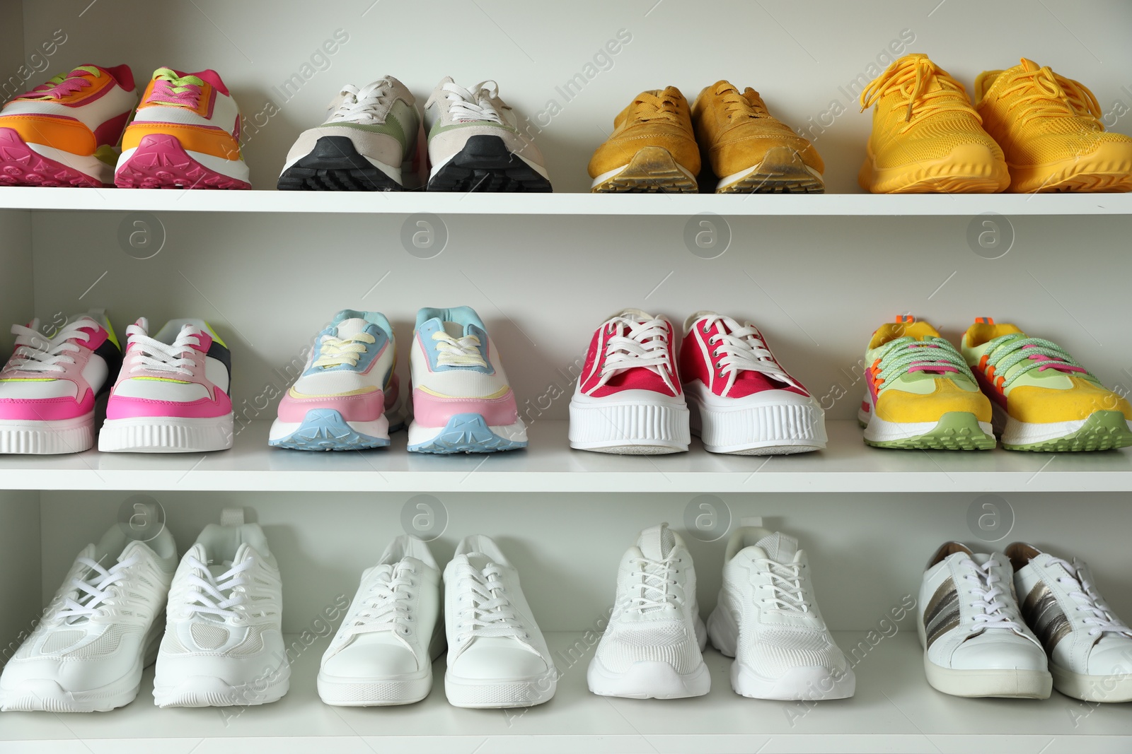 Different footwear on shelves indoors, closeup. Shoe storage Photo of Different footwear on shelves indoors, closeup. Shoe storage