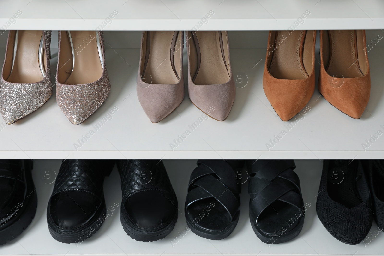 Different footwear on shelves indoors, closeup. Shoe storage Photo of Different footwear on shelves indoors, closeup. Shoe storage
