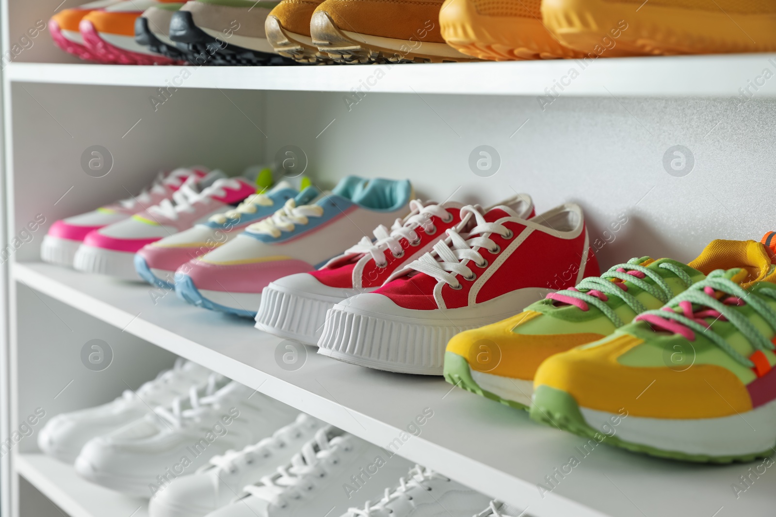 Different footwear on shelves indoors, closeup. Shoe storage Photo of Different footwear on shelves indoors, closeup. Shoe storage