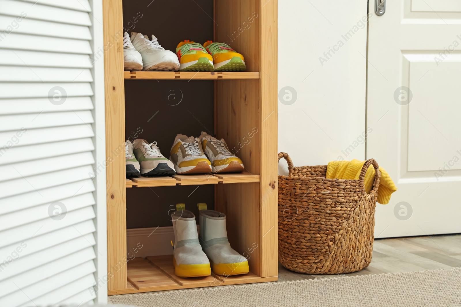 Different footwear on shelves in entryway. Shoe storage Photo of Different footwear on shelves in entryway. Shoe storage