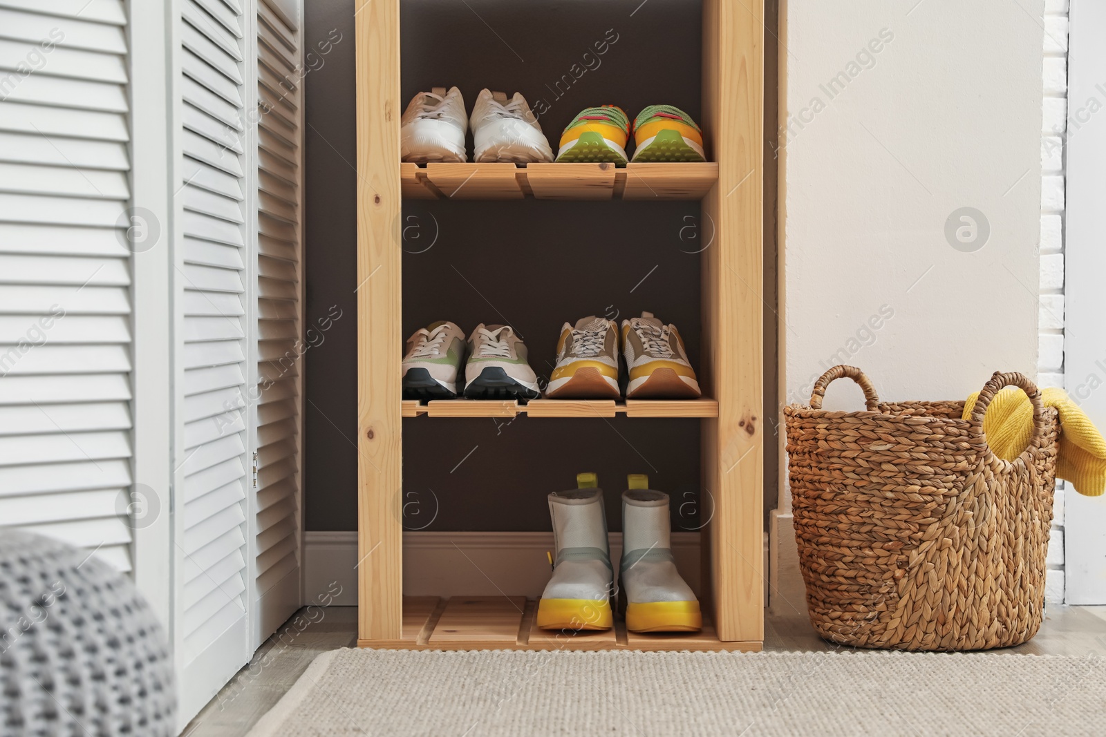 Different footwear on shelves in entryway. Shoe storage Photo of Different footwear on shelves in entryway. Shoe storage