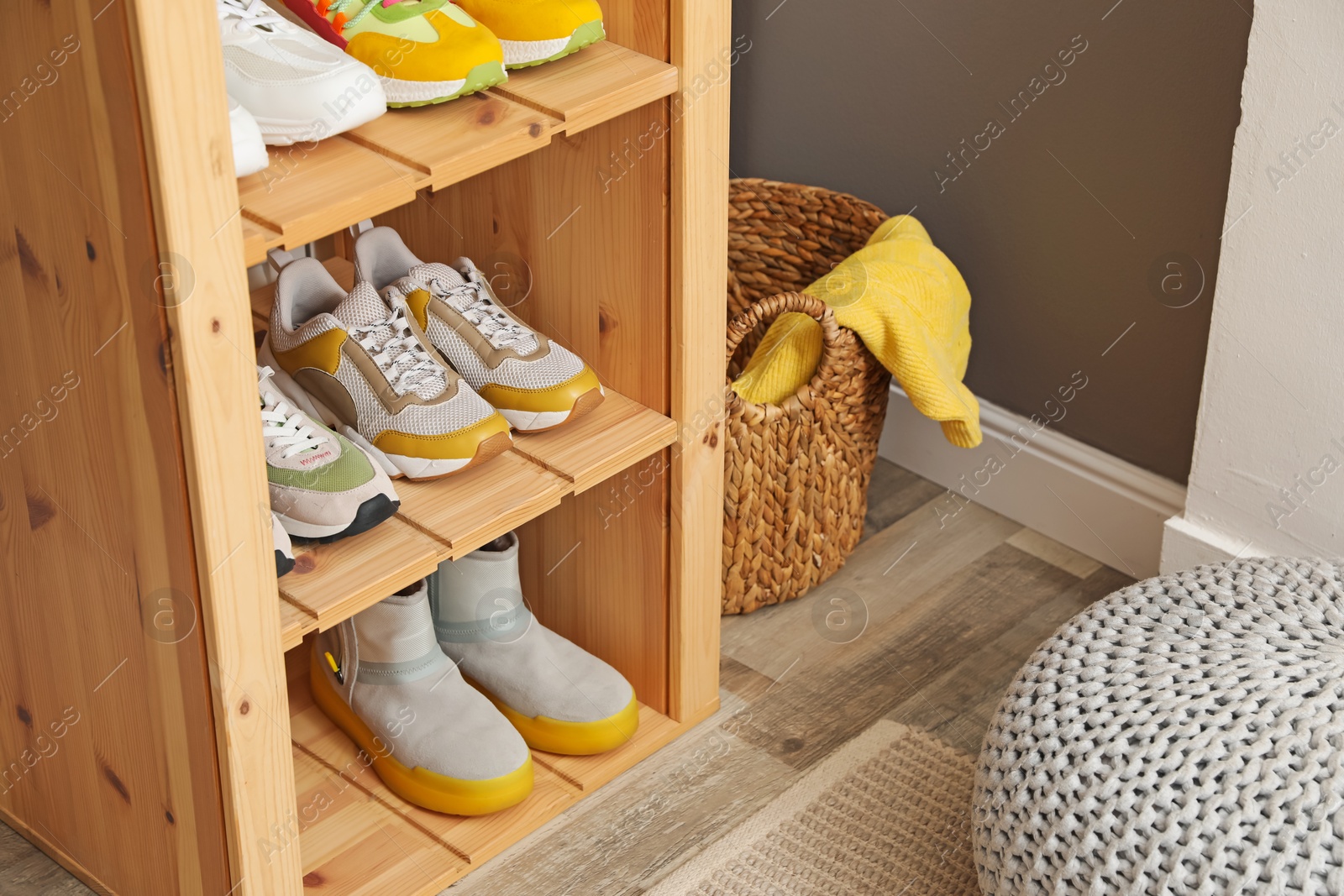 Different footwear on shelves in entryway, closeup. Shoe storage Photo of Different footwear on shelves in entryway, closeup. Shoe storage