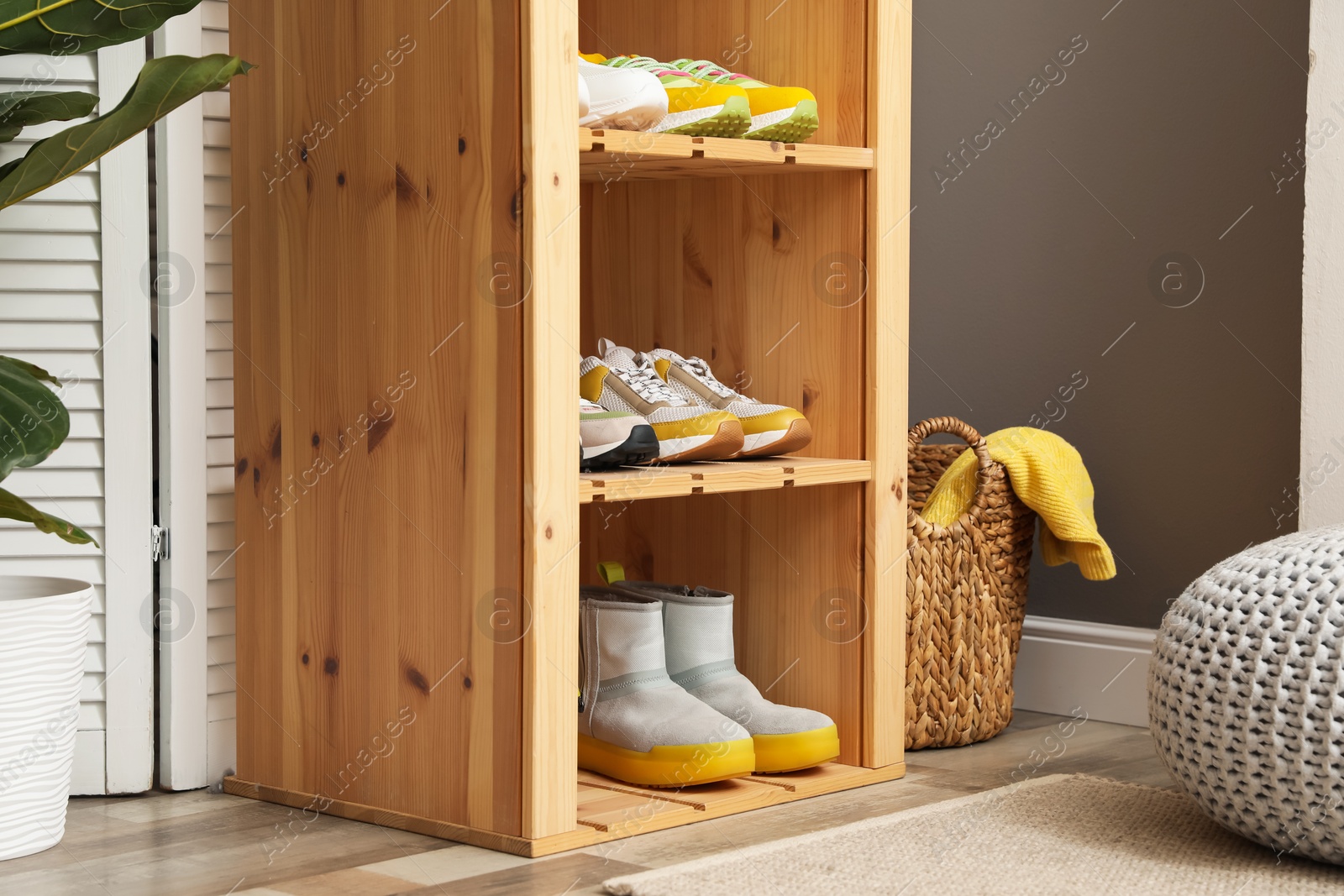 Different footwear on shelves in entryway. Shoe storage Photo of Different footwear on shelves in entryway. Shoe storage