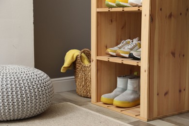 Photo of Different footwear on shelves in entryway. Shoe storage