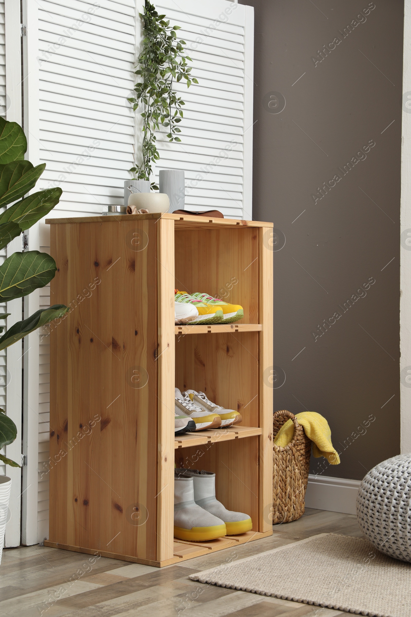 Different footwear on shelves in entryway. Shoe storage Photo of Different footwear on shelves in entryway. Shoe storage