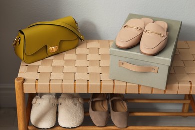 Photo of Different footwear on bench indoors. Shoe storage