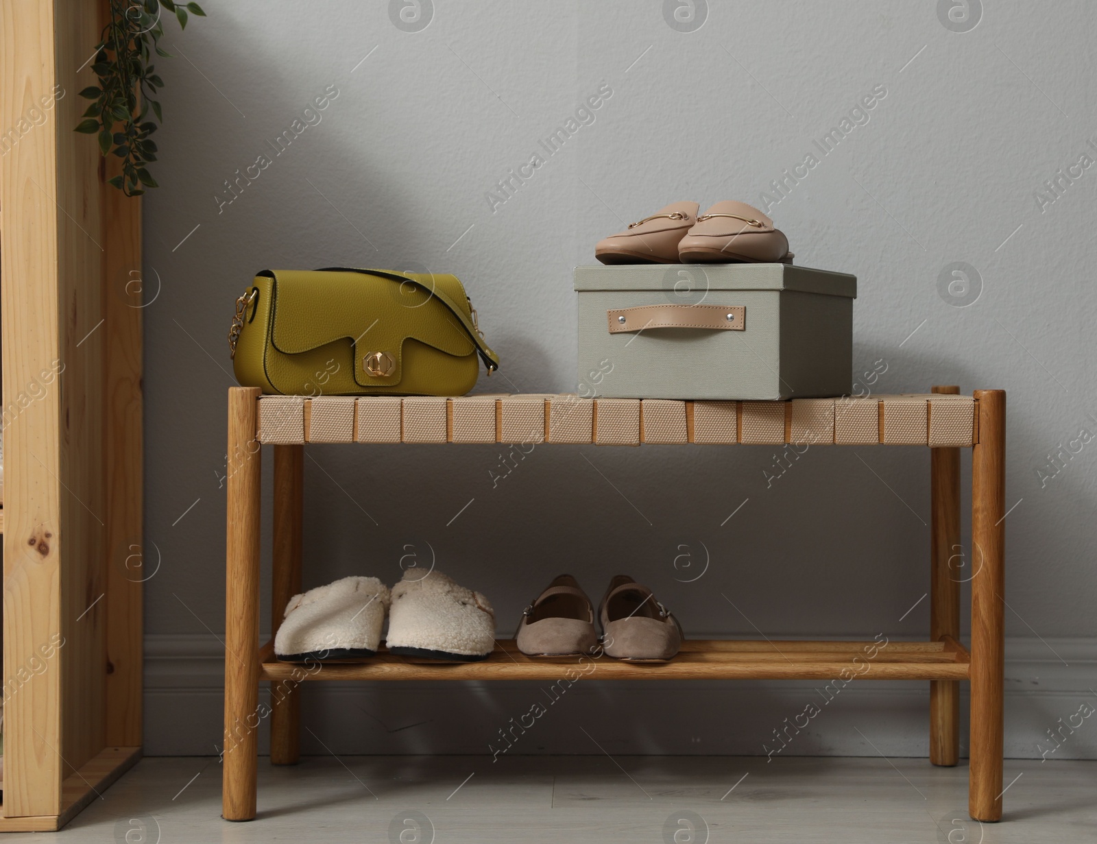 Different footwear on bench indoors. Shoe storage Photo of Different footwear on bench indoors. Shoe storage