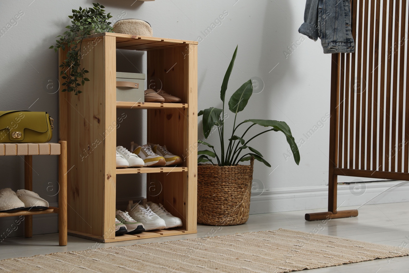 Different footwear on shelves in entryway. Shoe storage Photo of Different footwear on shelves in entryway. Shoe storage