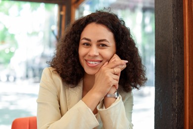 Photo of Portrait of smiling Latin American woman in cafe
