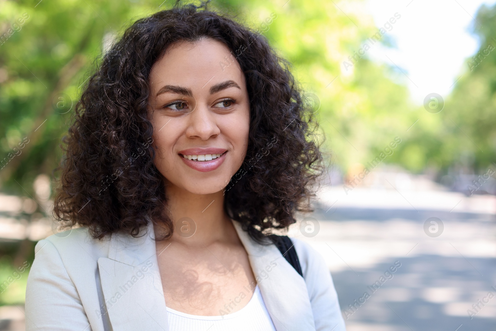 Portrait of smiling Latin American woman outdoors. Space for text Photo of Portrait of smiling Latin American woman outdoors. Space for text