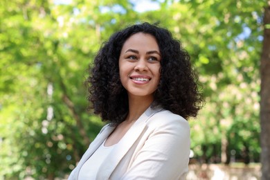 Photo of Portrait of smiling Latin American woman outdoors