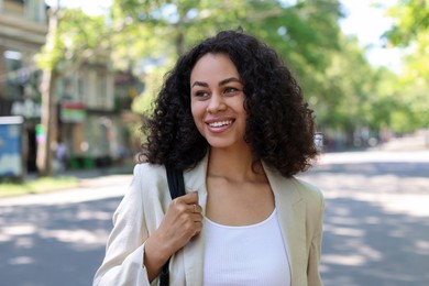 Photo of Portrait of smiling Latin American woman outdoors
