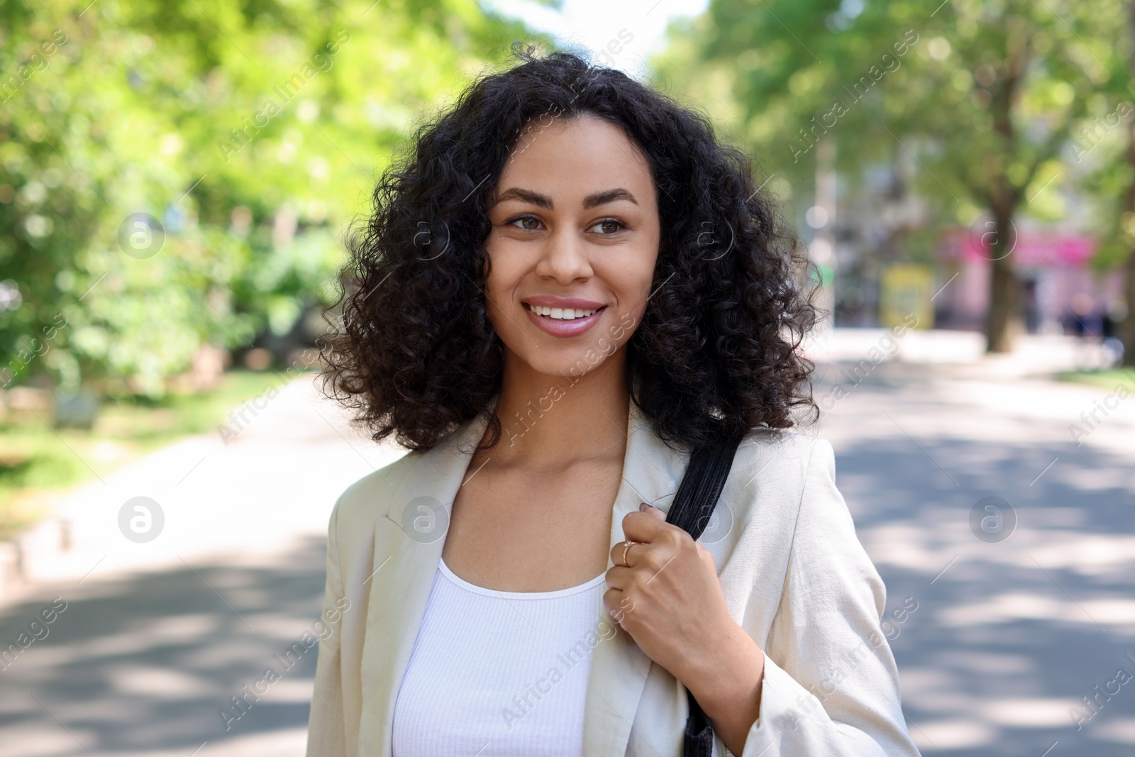 Photo of Portrait of smiling Latin American woman outdoors