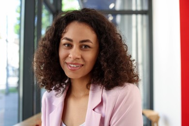 Photo of Portrait of smiling Latin American woman in cafe