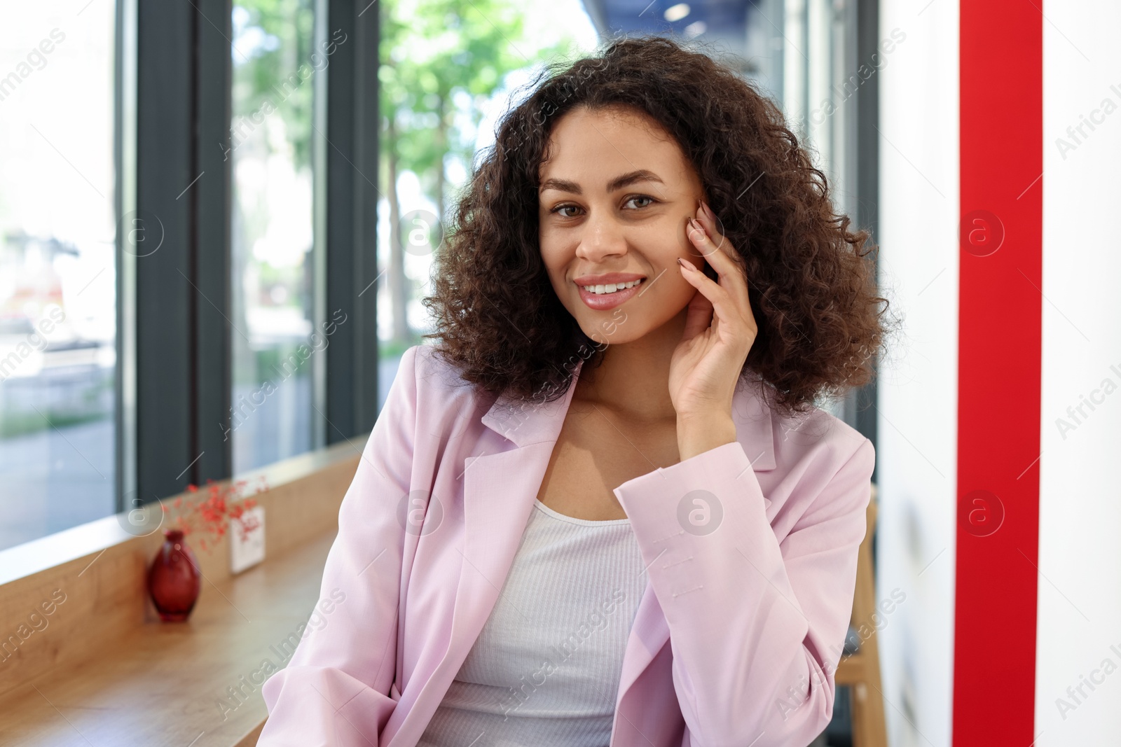 Portrait of smiling Latin American woman in cafe Photo of Portrait of smiling Latin American woman in cafe