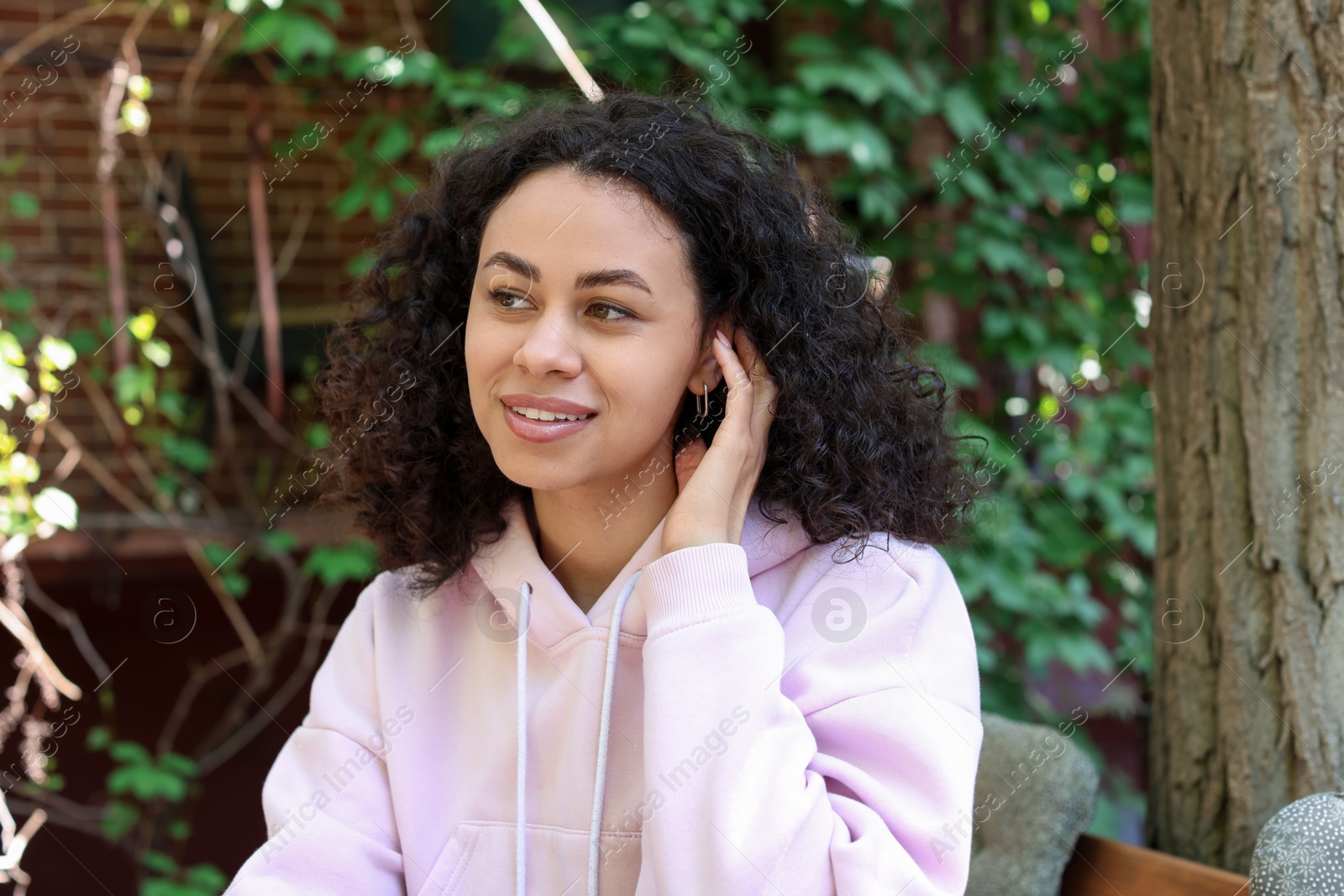 Photo of Portrait of smiling Latin American woman outdoors