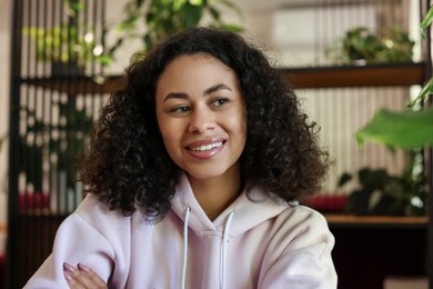 Photo of Portrait of smiling Latin American woman indoors