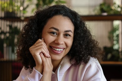 Photo of Portrait of smiling Latin American woman indoors