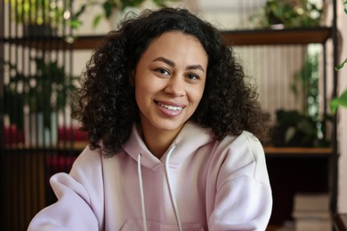 Photo of Portrait of smiling Latin American woman indoors