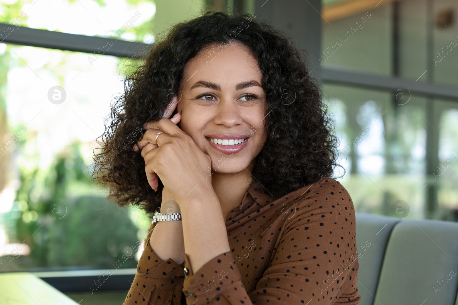 Portrait of smiling Latin American woman in cafe Photo of Portrait of smiling Latin American woman in cafe