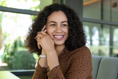 Photo of Portrait of smiling Latin American woman in cafe
