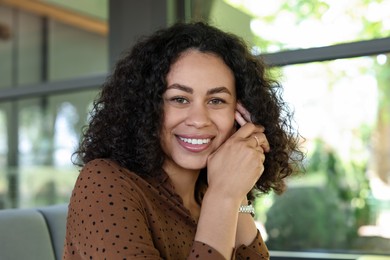 Photo of Portrait of smiling Latin American woman in cafe