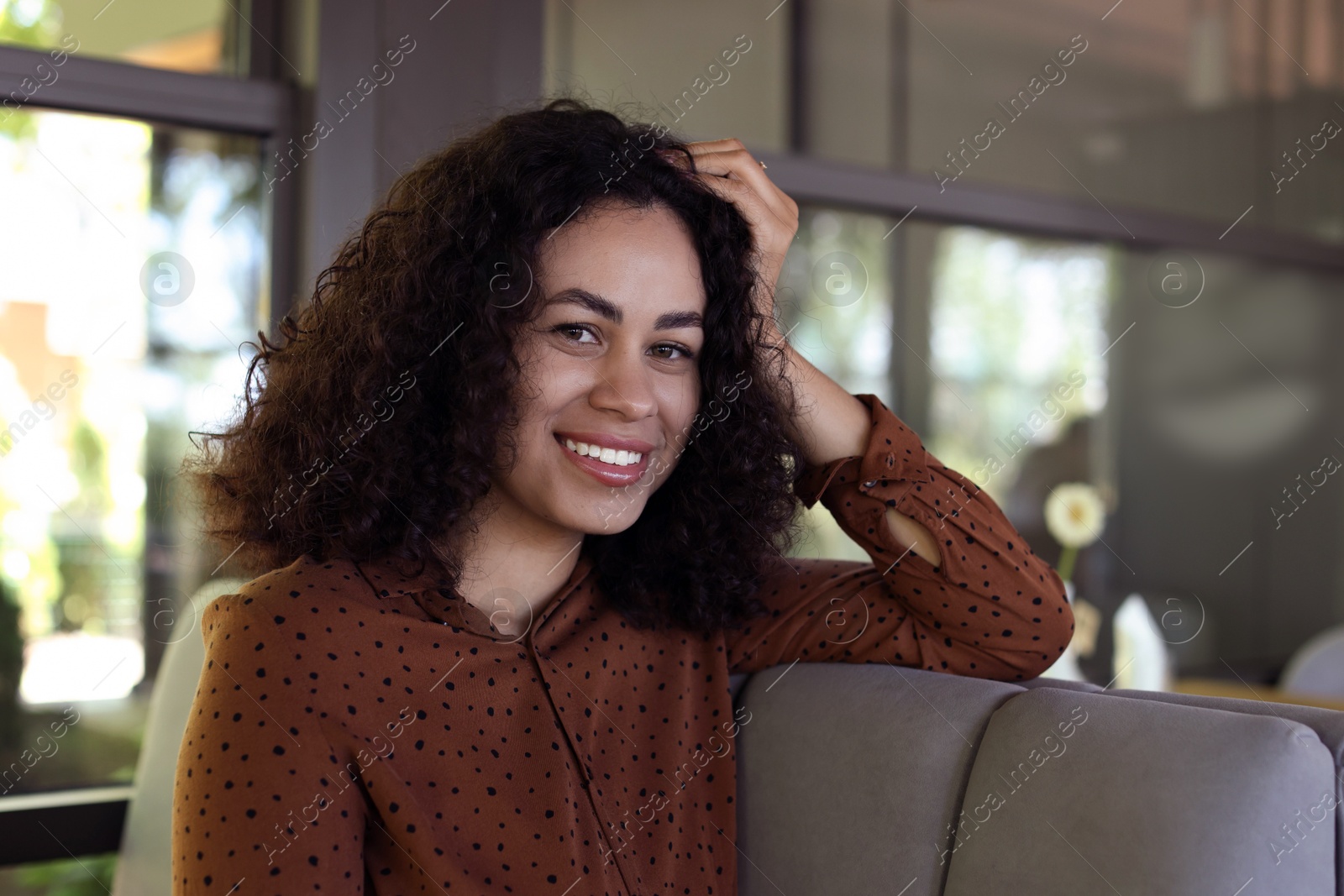 Portrait of smiling Latin American woman in cafe Photo of Portrait of smiling Latin American woman in cafe