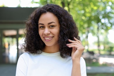 Photo of Portrait of smiling Latin American woman outdoors
