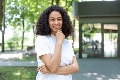 Photo of Portrait of smiling Latin American woman outdoors