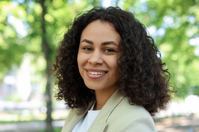 Photo of Portrait of smiling Latin American woman outdoors