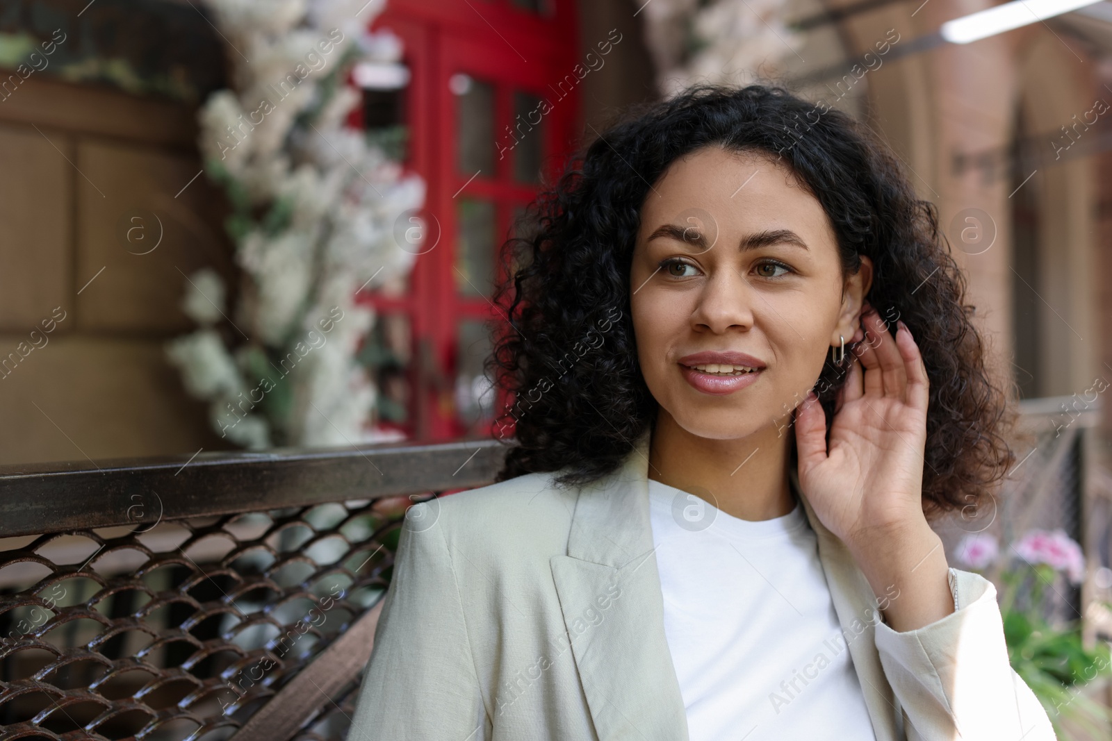 Photo of Portrait of smiling Latin American woman outdoors. Space for text