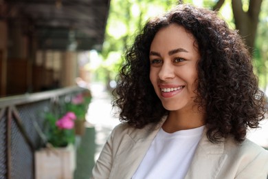 Photo of Portrait of smiling Latin American woman outdoors