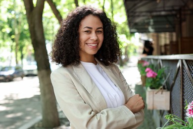 Photo of Portrait of smiling Latin American woman outdoors