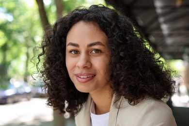 Photo of Portrait of smiling Latin American woman outdoors