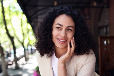 Photo of Portrait of smiling Latin American woman outdoors