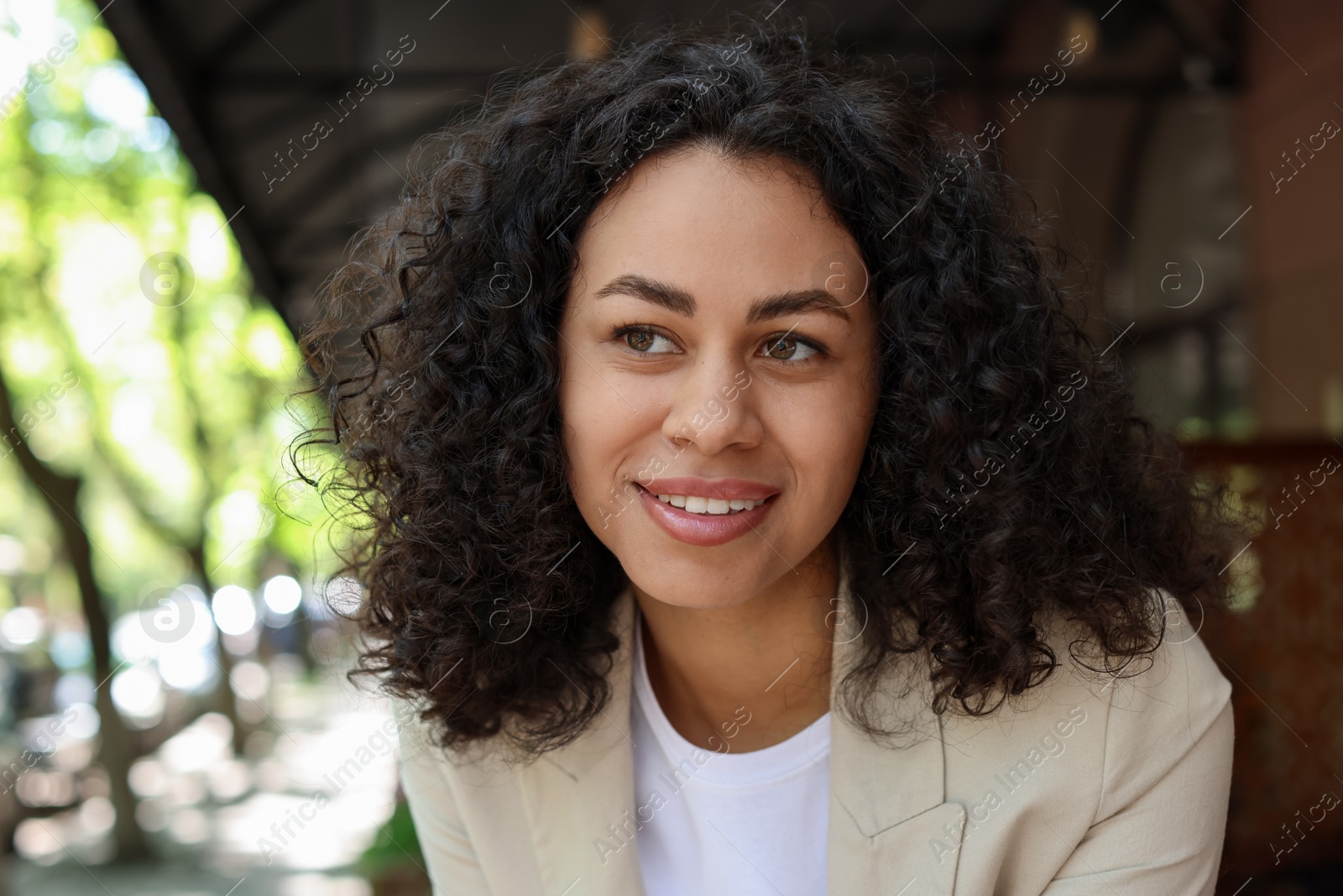 Photo of Portrait of smiling Latin American woman outdoors
