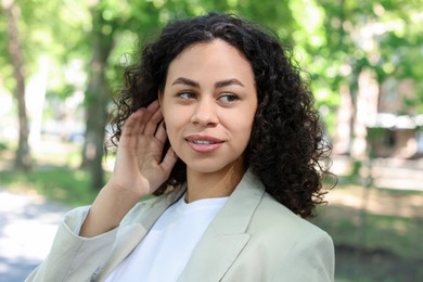 Photo of Portrait of smiling Latin American woman outdoors