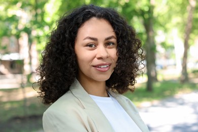 Photo of Portrait of smiling Latin American woman outdoors